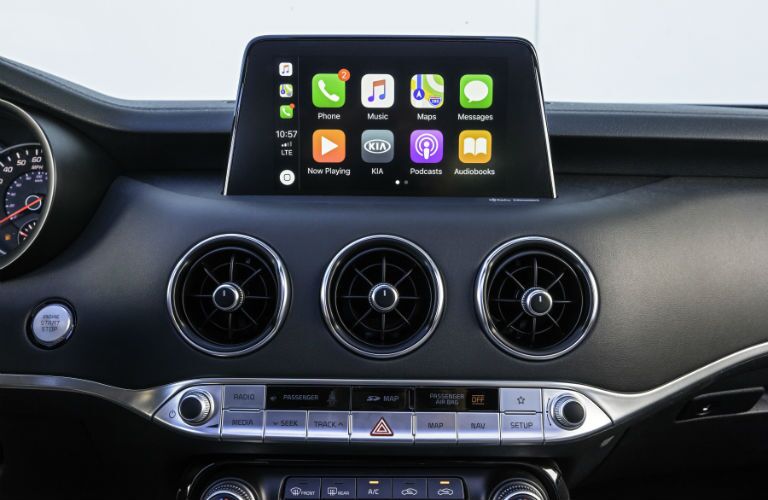 An interior photo showing the infotainment system paired to a smartphone in the 2018 Kia Stinger.