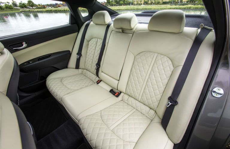 An interior photo of the 2018 Kia Optima and how passenger space is in the back seat.