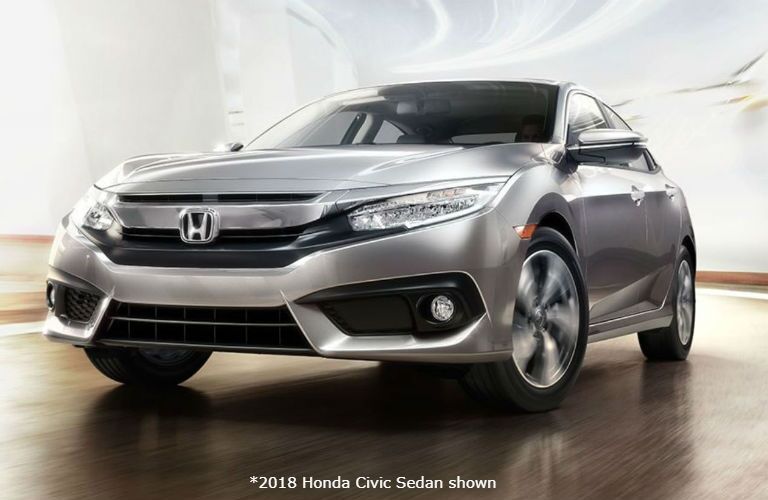 2018 Honda Civic Sedan driving up a bright ramp