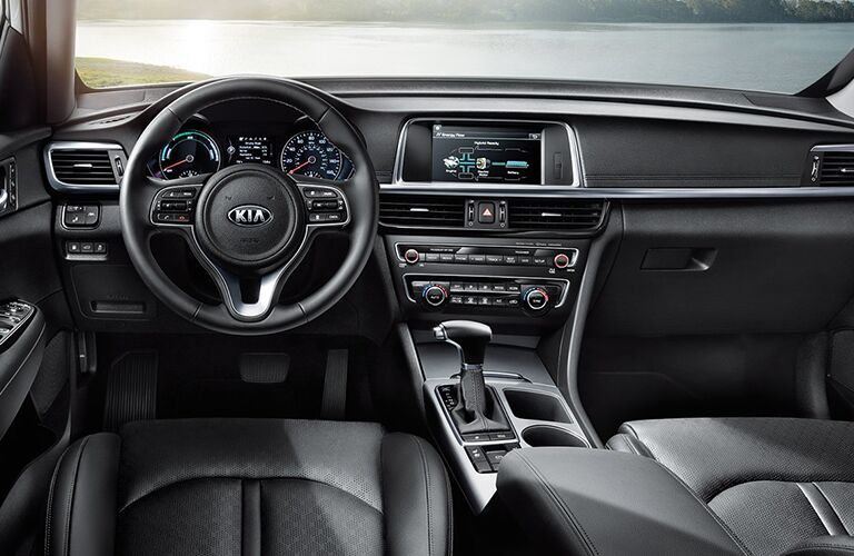 front interior of 2018 kia optima hybrid including steering wheel and infotainment system