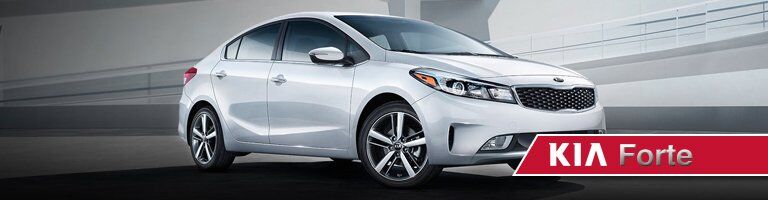 white 2019 Kia Forte with banner