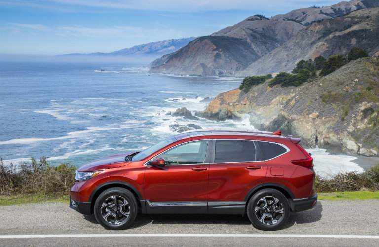 2018 Honda CR-V parked by wide shot of waves and cliffs