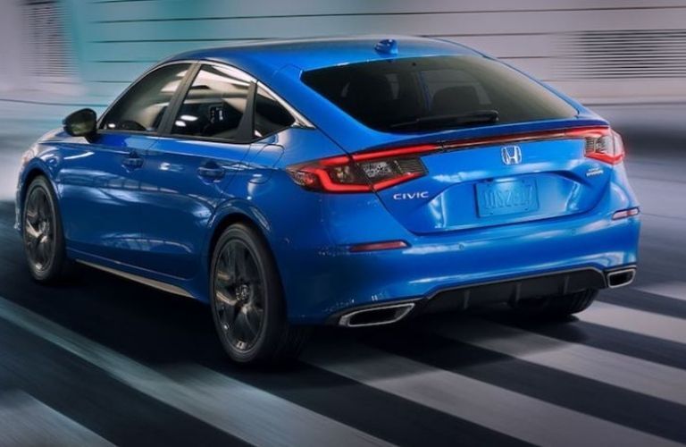 Rear tailgate view of a blue 2022 Honda Civic Hatchback on road