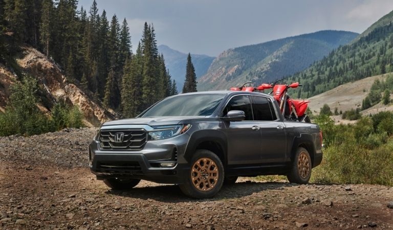 Gray 2021 Honda Ridgeline on a Trail with Dirt Bikes in Back