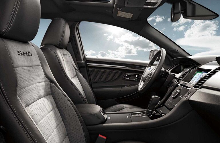 side view of front interior of 2019 ford taurus including seats and center console