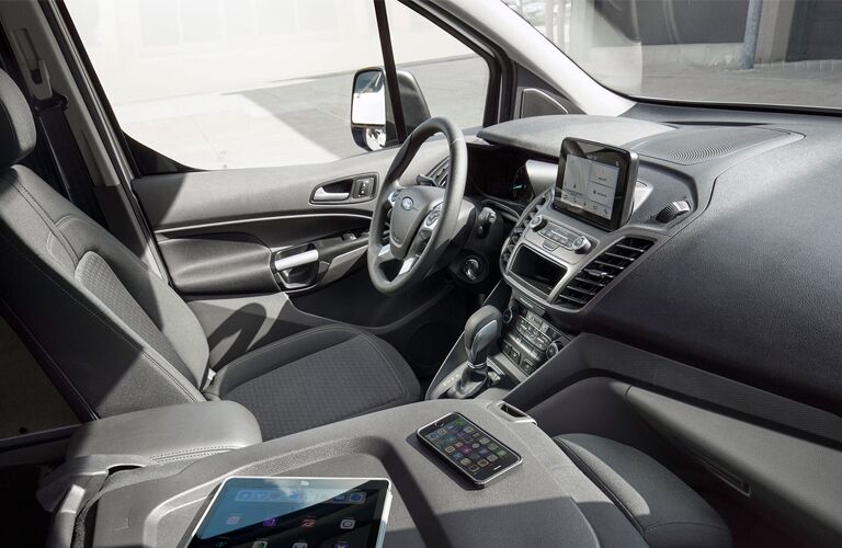 front interior of 2019 ford transit connect cargo van including steering wheel and infotainment system