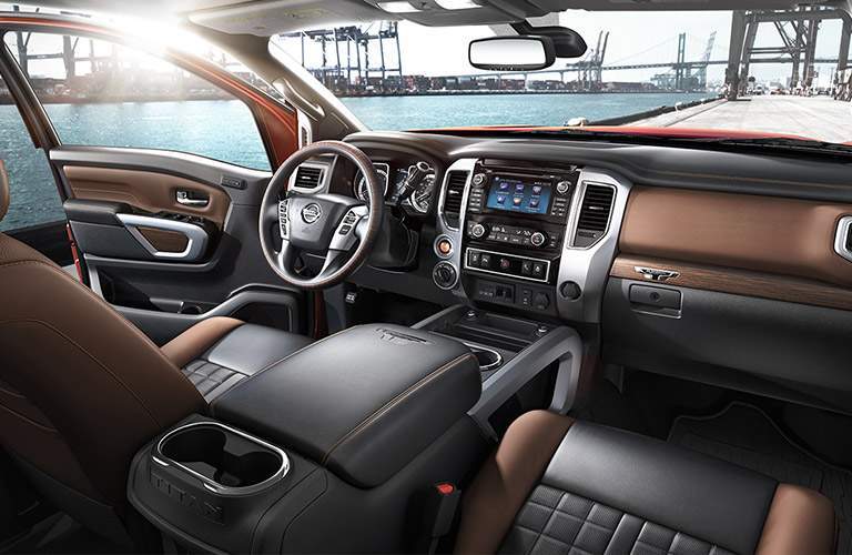 interior cabin of 2017 nissan titan xd showing dashboard, center console, steering wheel and infotainment system