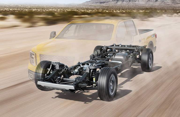 2017 nissan titan xd with body frame and chasis highlighted while driving on desert road