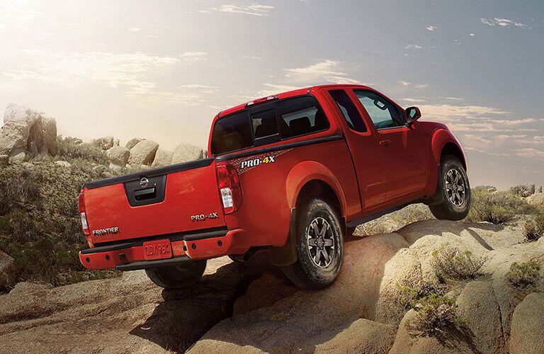 2018 Nissan Frontier rearview driving on dirt