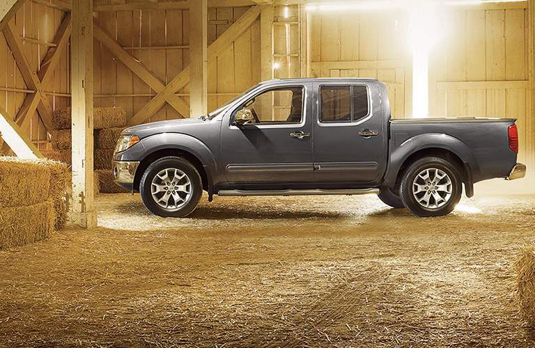 gray nissan frontier parked inside a barn