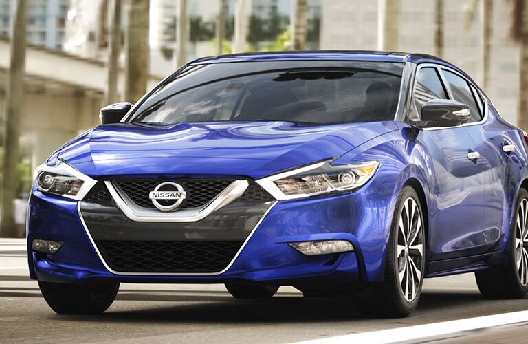 blue nissan maxima, silver v-motion grille, front of car
