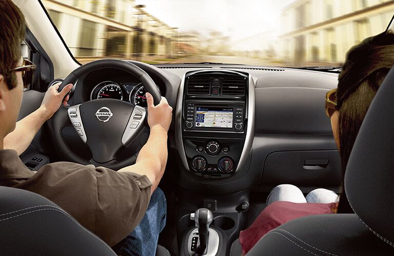 people in front seats of nissan versa