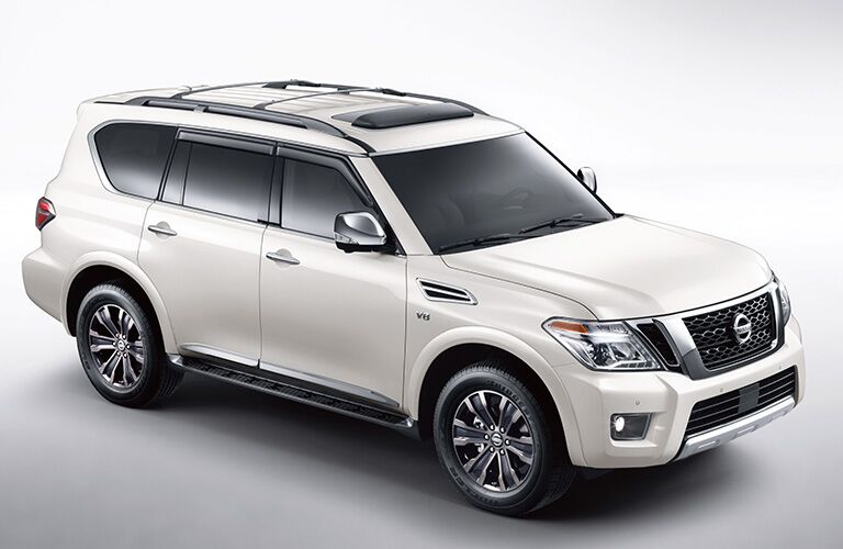 Exterior view of a white 2019 Nissan Armada parked in a white showroom