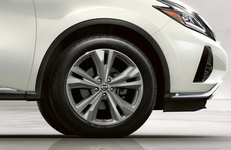 Exterior view of the front passenger's side tire on a white 2019 Nissan Murano