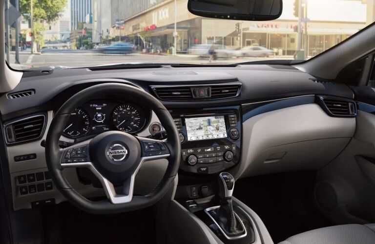 Interior view of the steering wheel and navigation screen inside a 2019 Nissan Rogue Sport