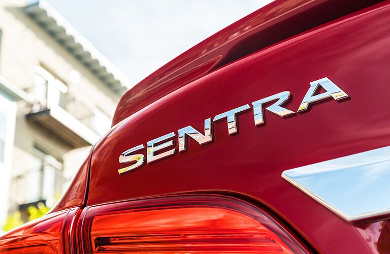 Sentra badge on rear bumper of red 2019 Nissan Sentra