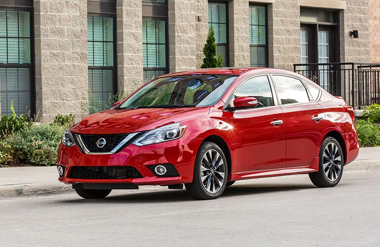 Exterior view of a red 2019 Nissan Sentra parked on a city street