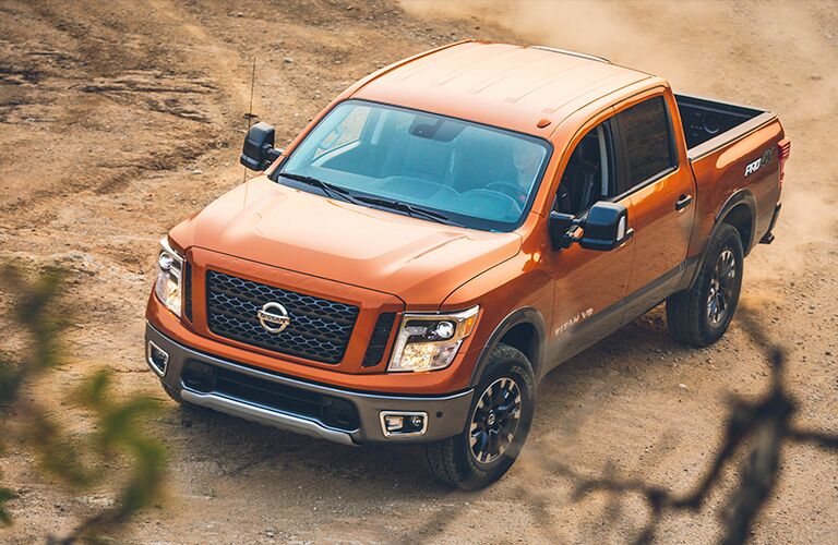 Exterior view of an orange 2019 Nissan Frontier parked in the desert