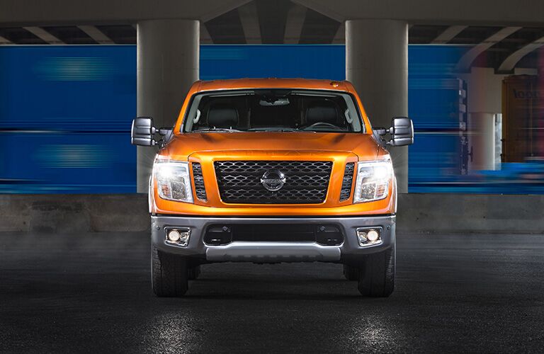 Exterior view of the front of an orange 2019 Nissan TITAN parked in a parking garage
