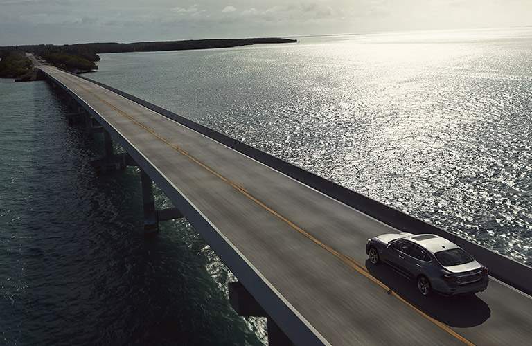 infiniti q70 driving on bridge over water