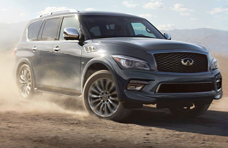 gray QX80 driving on dirt
