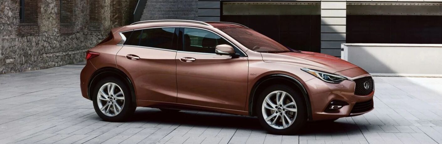Exterior view of a bronze 2019 INFINITI QX30 parked in a driveway