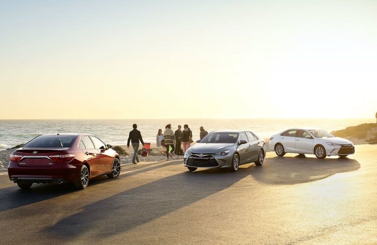 three 2017 Toyota Camry models parked by ocean