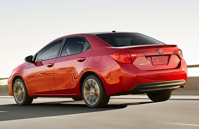 Red 2017 Toyota Corolla driving on highway