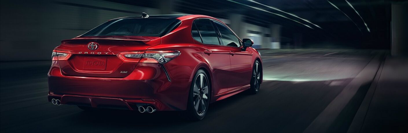 Red 2018 Toyota Camry driving through tunnel