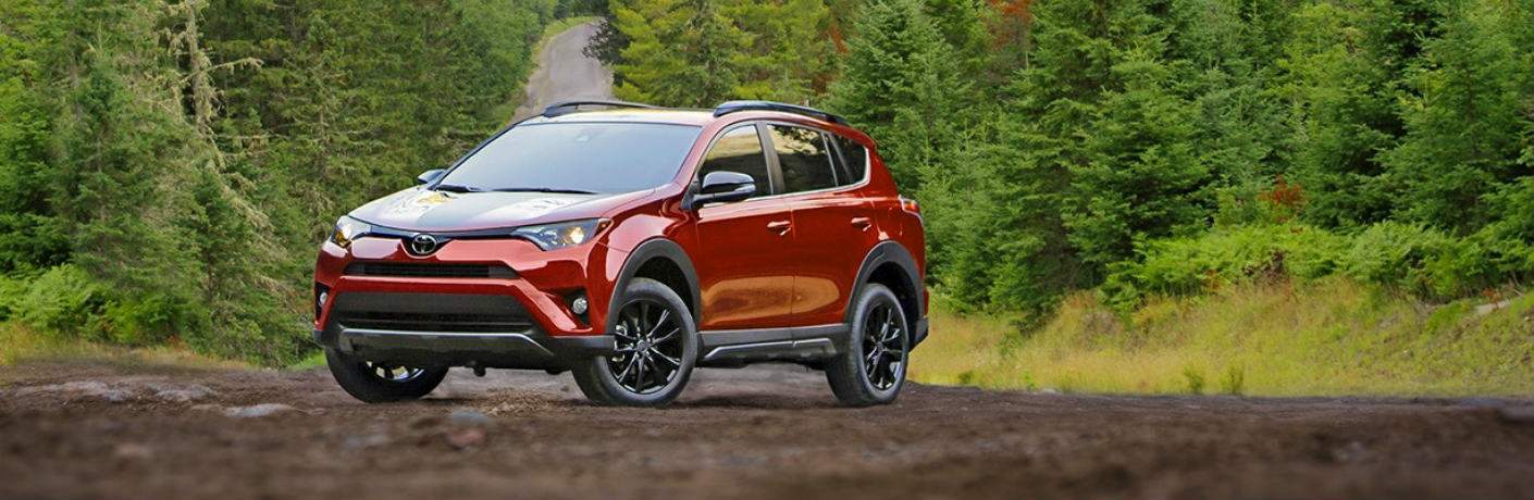 red 2018 Toyota RAV4 Adventure parked on dirt road