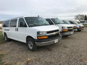 Passenger side exterior view of white Chevy Express