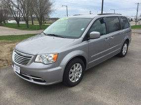 Driver's side exterior view of a grey Chrysler Town & Country