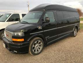 Driver's side exterior view of black GMC Savana