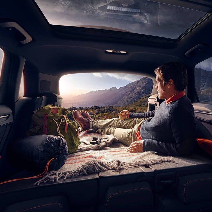 A man lying in the back of the 2019 Q3