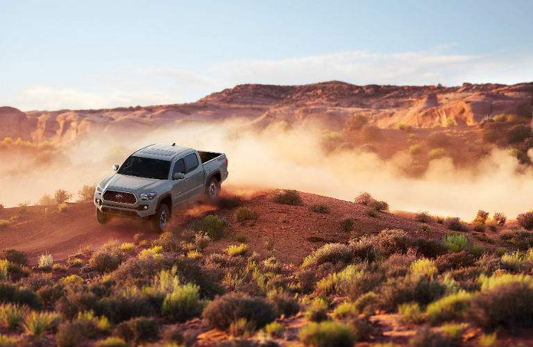 A photo of a 2018 Toyota cresting an obstacle during an off-road run