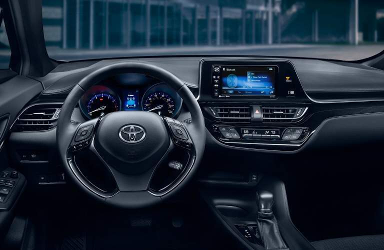 A photo showing the driver's cockpit of the 2018 C-HR including the gauge cluster and infotainment system
