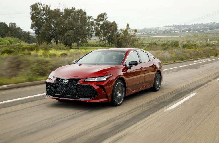 A front left quarter photo of the 2019 Toyota Avalon in motion on the road.