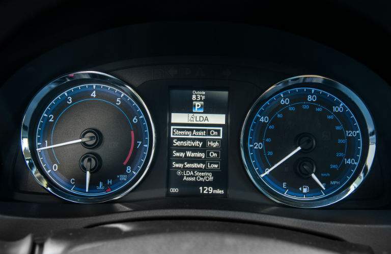 Center gauge cluster showing active safety systems activated