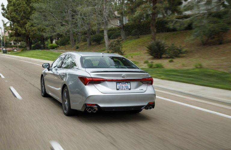 A rear photo of the 2019 Toyota Avalon in motion on the road.