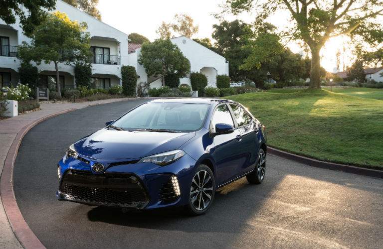 Blue 2018 Toyota Corolla in a driveway showing a front quarter view