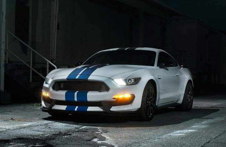 White 2018 Ford Mustang Shelby GT350® with Blue Pinstripes in Dark Alley with Lights On