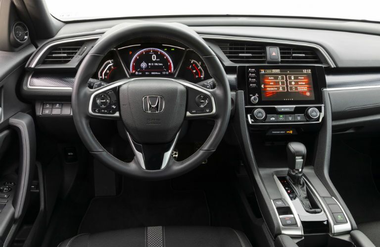 A photo of the driver's cockpit in the 2019 Honda Civic Coupe.