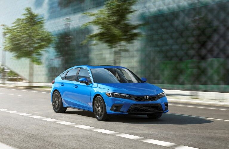 The 2022 Honda Civic Hatchback on a city road.