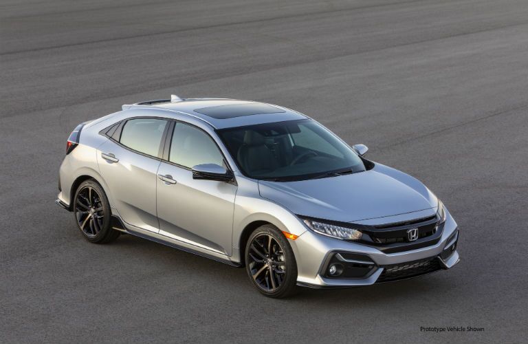 A photo of the 2021 Honda Civic Hatchback in a parking lot.