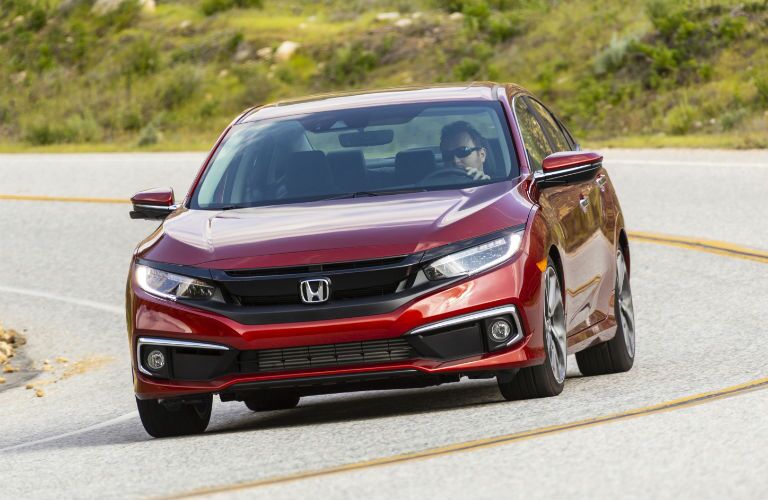 A head-on photo of the 2021 Honda Civic Sedan on the road.