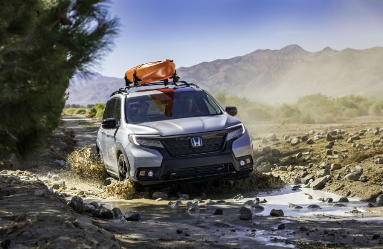 A photo of the 2020 Honda Passport going through a mud hole.