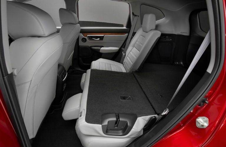 A photo of the rear seats with one folded down in the 2020 Honda CR-V Hybrid.