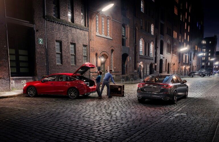 Two 2022 Honda Civic Hatchback models parked in an alley.