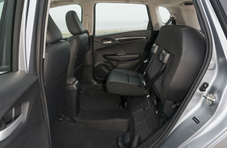 A photo of the rear seats of the 2019 Honda Fit flipped up for under-seat storage.