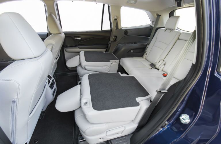 A photo of the second row folded down in the 2021 Honda Pilot.